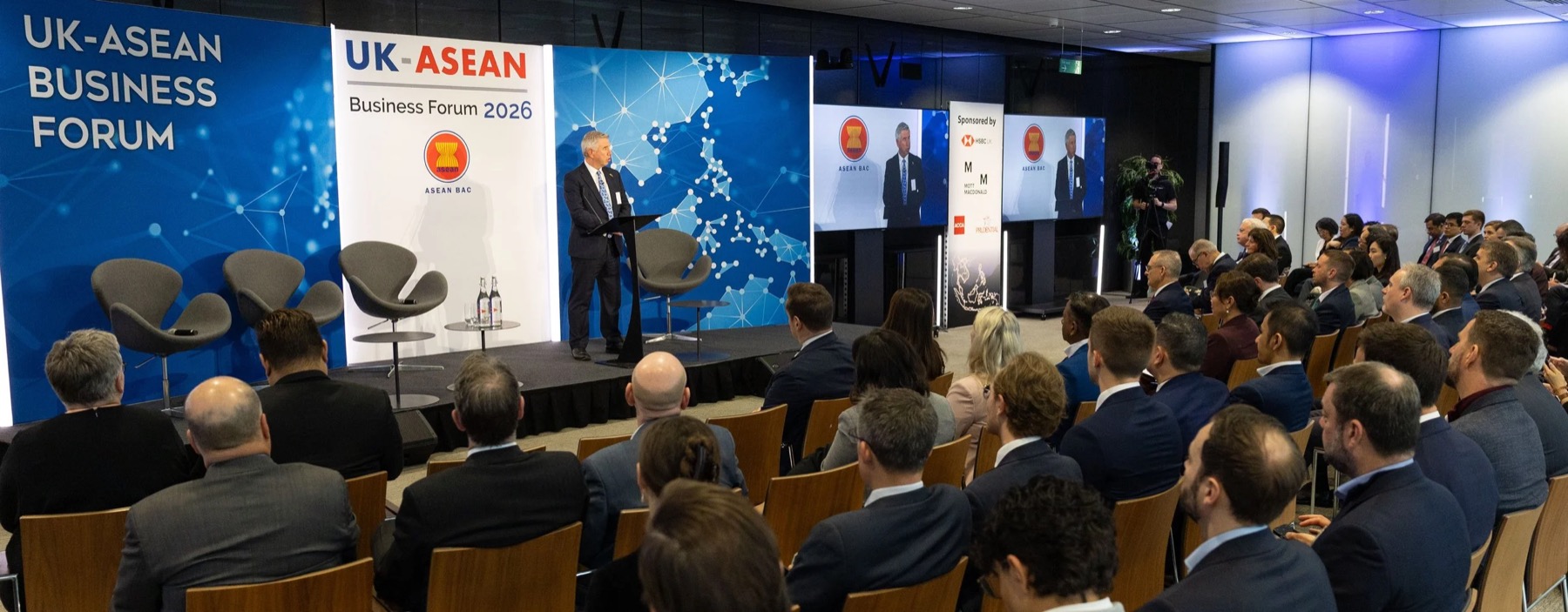 A wide view of the UK-ASEAN Business Forum 2026, a speaker on stage and a full room of delegates