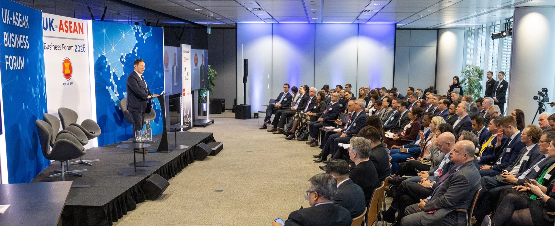A speaker at a lectern addressing a seated audience at the UK-ASEAN Business Forum 2026